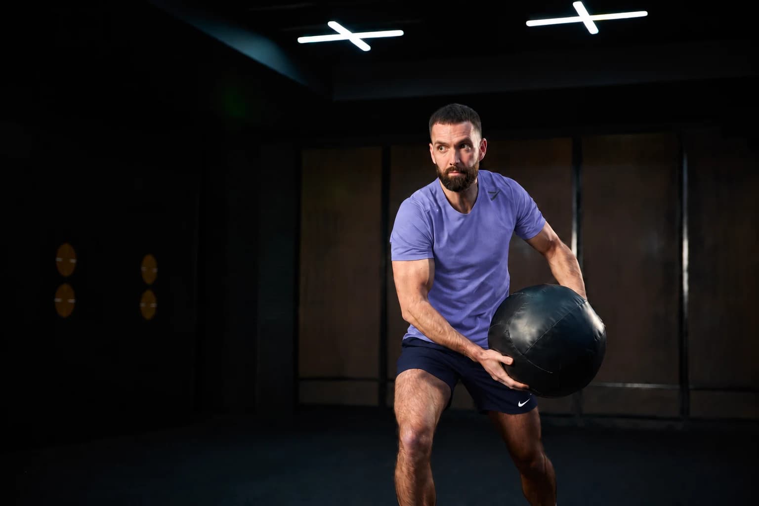 Paul training with a medicine ball in a gym